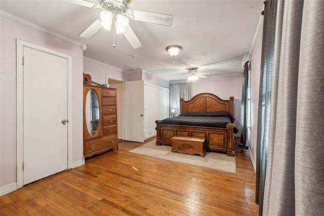 bedroom featuring ceiling fan, crown molding, and light hardwood / wood-style flooring