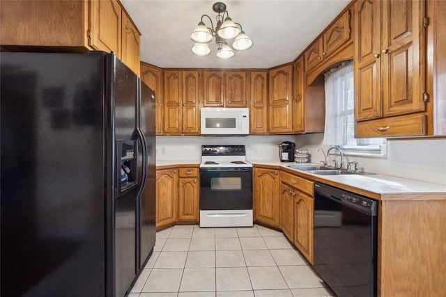 kitchen with black appliances, a notable chandelier, light tile patterned floors, and sink