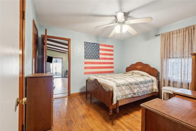 bedroom with ceiling fan and wood-type flooring