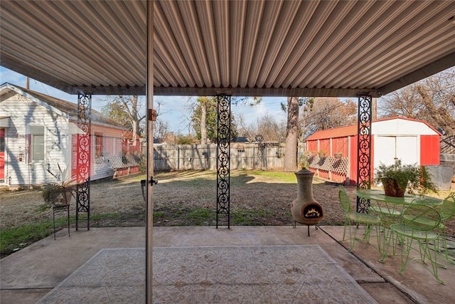 view of patio with a storage shed