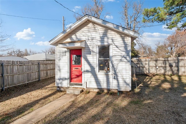 rear view of property with an outbuilding