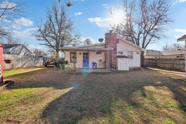 rear view of property featuring a lawn and a patio