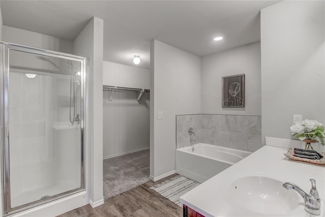 bathroom featuring vanity, hardwood / wood-style flooring, and separate shower and tub