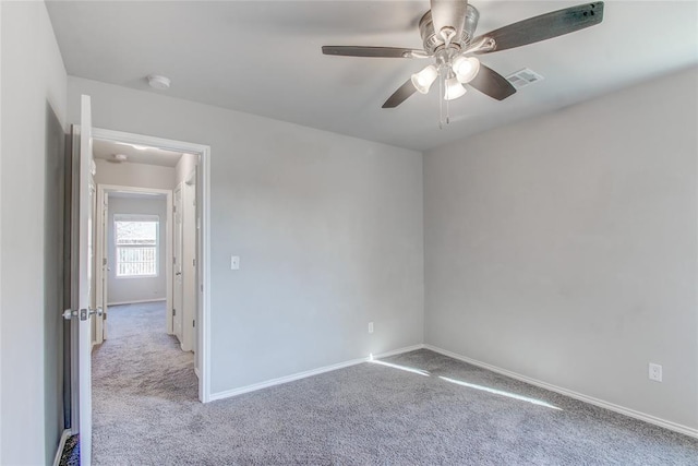 spare room featuring light carpet and ceiling fan