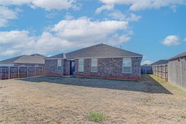 rear view of property with a yard