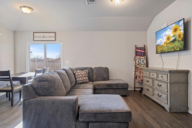 living room featuring dark wood-type flooring and lofted ceiling