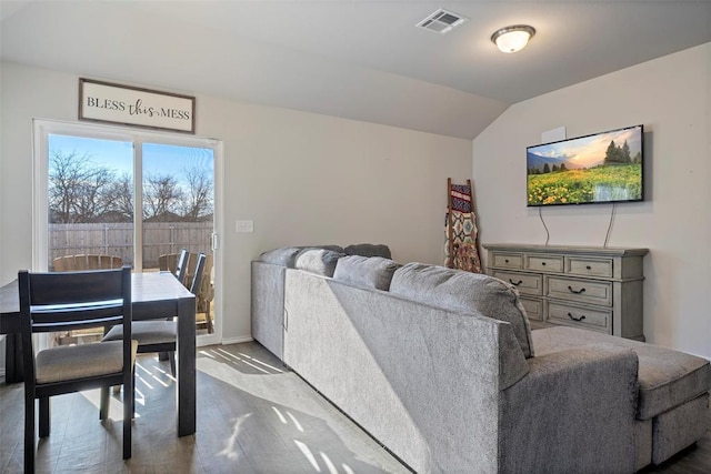 living room featuring lofted ceiling