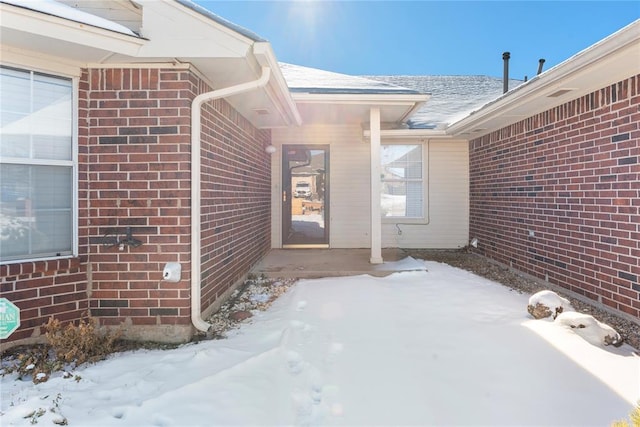 view of snow covered property entrance