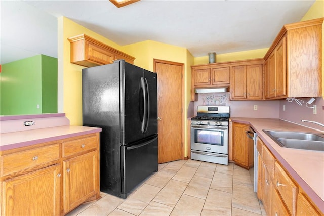 kitchen with sink, light tile patterned floors, and stainless steel appliances