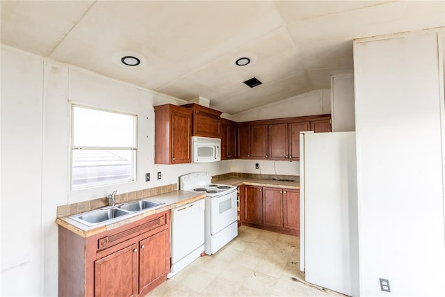 kitchen with vaulted ceiling, sink, and white appliances