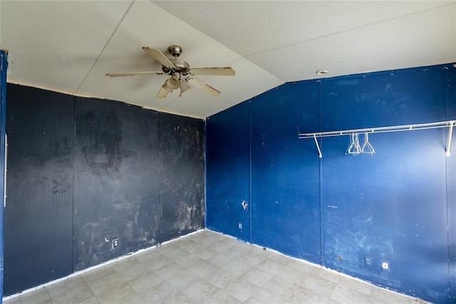 spare room featuring vaulted ceiling and ceiling fan