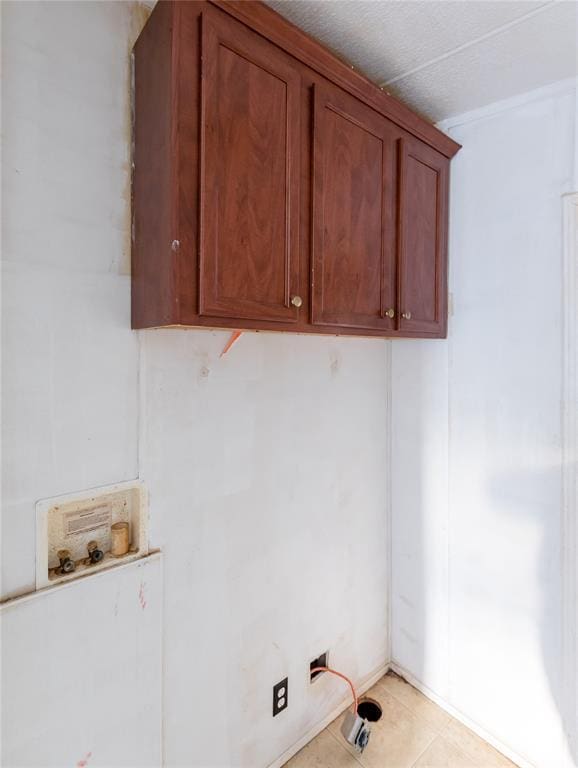 laundry area featuring hookup for a washing machine and light tile patterned flooring