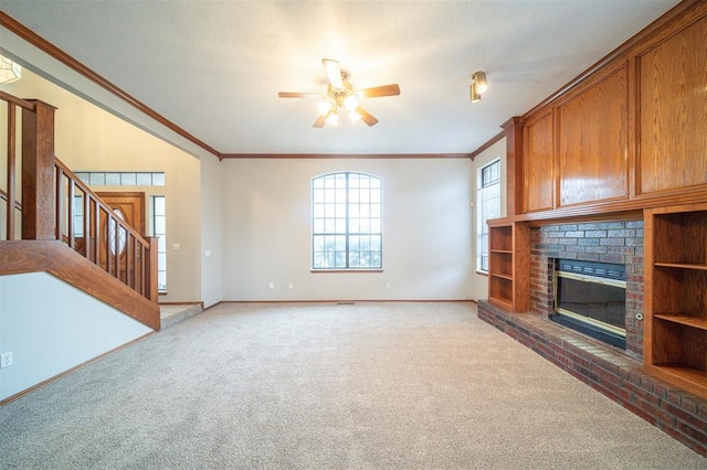 unfurnished living room with carpet floors, a brick fireplace, ceiling fan, and ornamental molding