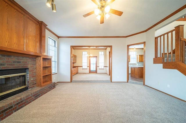 living room featuring light carpet, a fireplace, ornamental molding, and ceiling fan