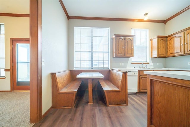 kitchen with dark hardwood / wood-style flooring, sink, dishwasher, and ornamental molding