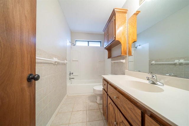 full bathroom featuring tile patterned flooring, toilet, shower / tub combination, vanity, and tile walls