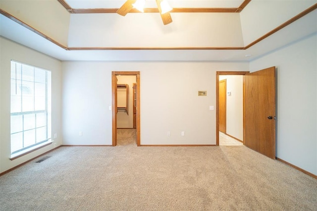 spare room with light carpet, crown molding, ceiling fan, and a healthy amount of sunlight