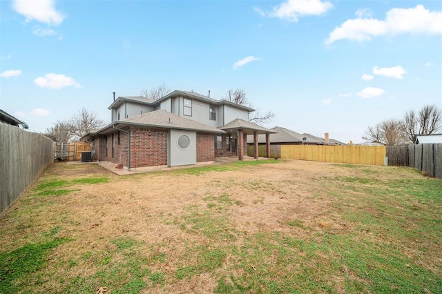 back of house with a patio area, a yard, and central AC unit