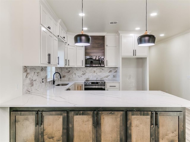 kitchen with light stone countertops, white cabinetry, hanging light fixtures, decorative backsplash, and appliances with stainless steel finishes