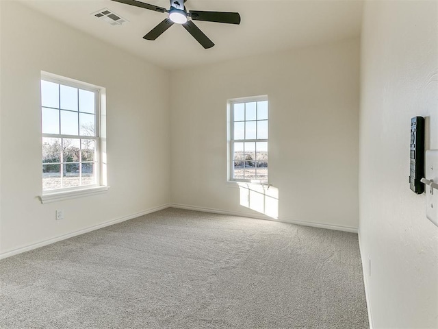 spare room with carpet, radiator, and ceiling fan