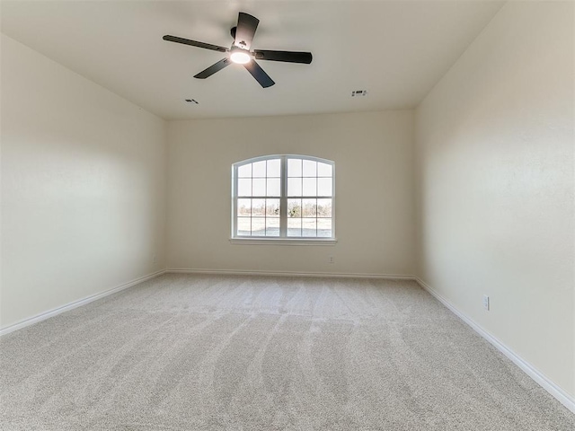 spare room with light carpet and ceiling fan