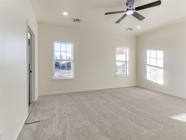 carpeted spare room with ceiling fan and crown molding