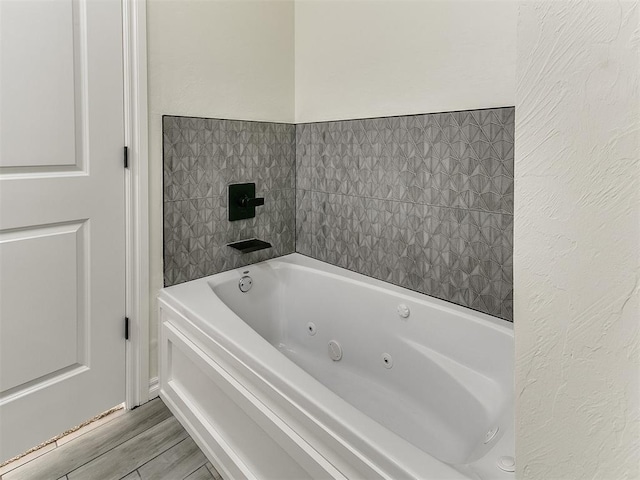 bathroom featuring a tub and hardwood / wood-style flooring