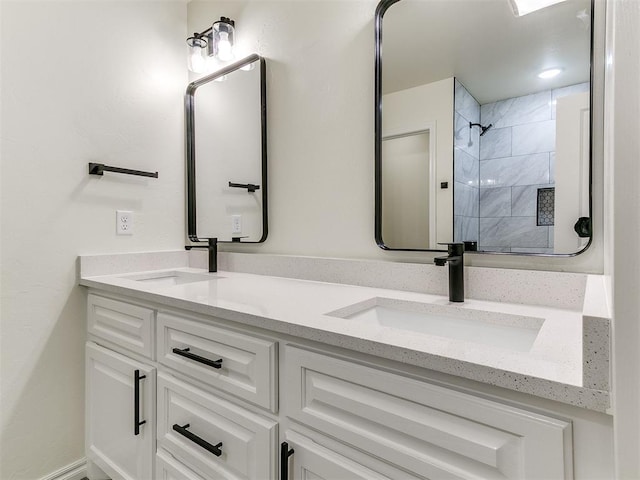 bathroom featuring vanity and tiled shower