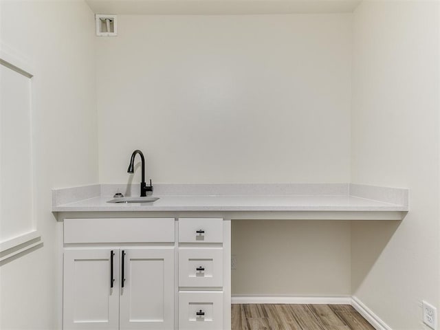 bathroom with hardwood / wood-style flooring and sink