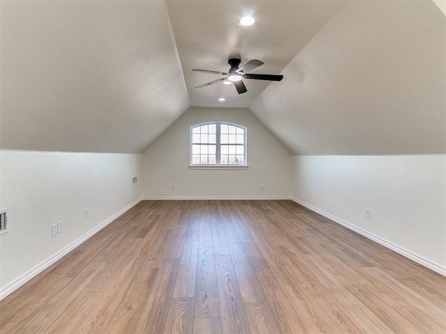 bonus room with lofted ceiling, ceiling fan, and light wood-type flooring