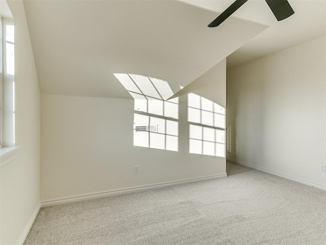 interior space featuring light colored carpet and vaulted ceiling