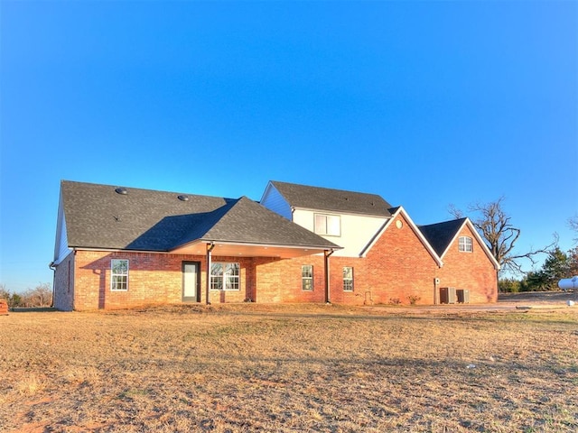 rear view of property featuring central AC unit