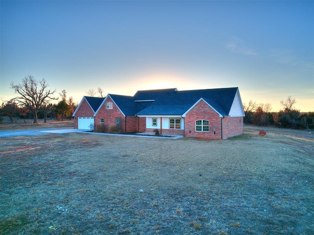 view of front of house with a yard and a garage