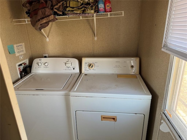 clothes washing area with washing machine and dryer