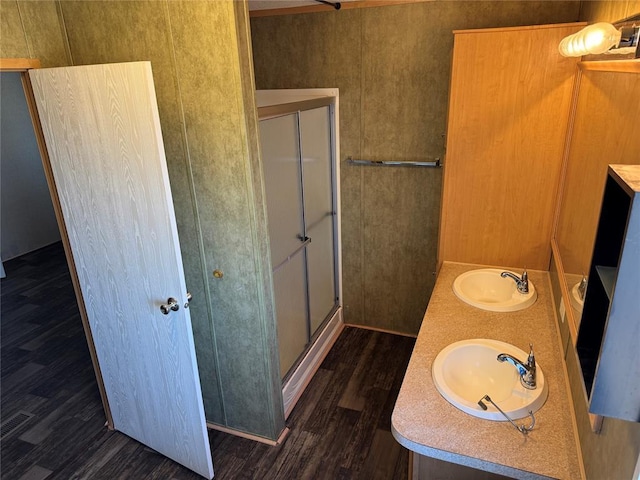 bathroom featuring vanity, wood-type flooring, and walk in shower