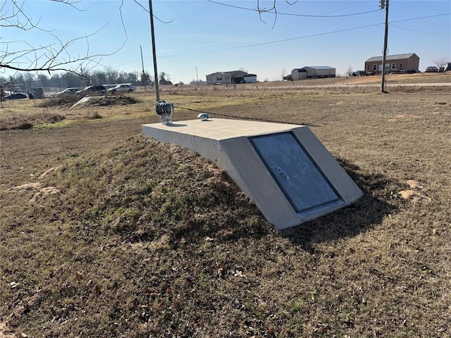 view of storm shelter featuring a lawn