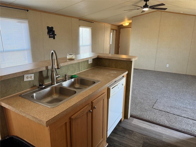 kitchen featuring sink, dishwasher, ceiling fan, dark carpet, and vaulted ceiling