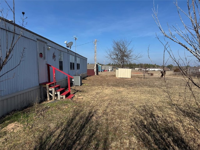 view of yard featuring central air condition unit