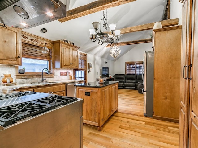 kitchen featuring backsplash, lofted ceiling with beams, a notable chandelier, a kitchen island, and stainless steel appliances