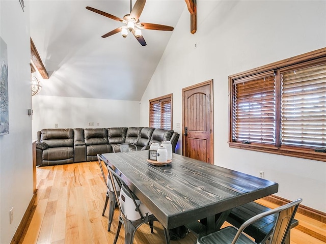 dining area with ceiling fan, high vaulted ceiling, and light hardwood / wood-style flooring