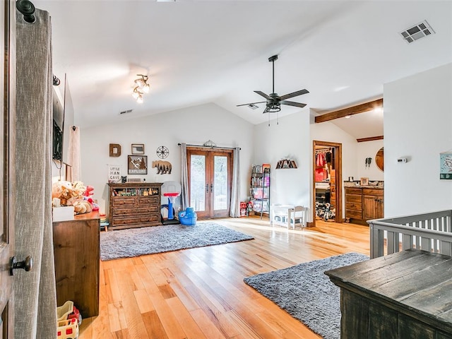 living room featuring hardwood / wood-style flooring, ceiling fan, lofted ceiling, and french doors