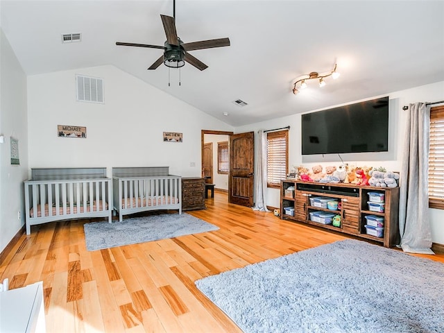 bedroom featuring ceiling fan, wood-type flooring, and lofted ceiling