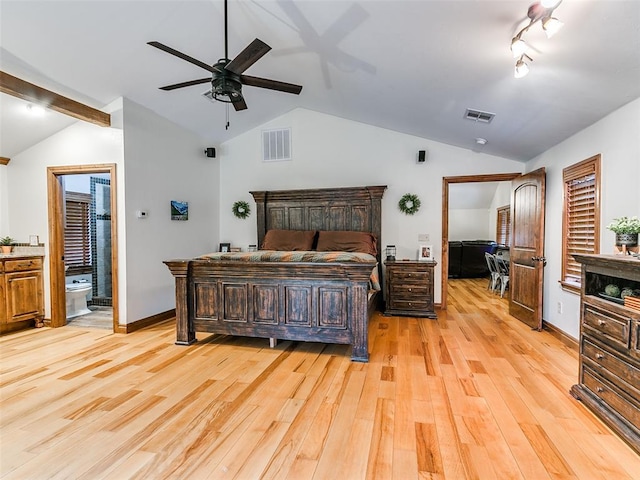 bedroom with ceiling fan, vaulted ceiling, connected bathroom, and light hardwood / wood-style flooring