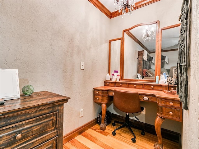 office area with a notable chandelier, crown molding, and light hardwood / wood-style flooring