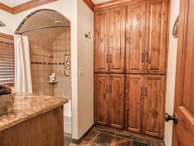 bathroom with vanity, shower / tub combo with curtain, and ornamental molding