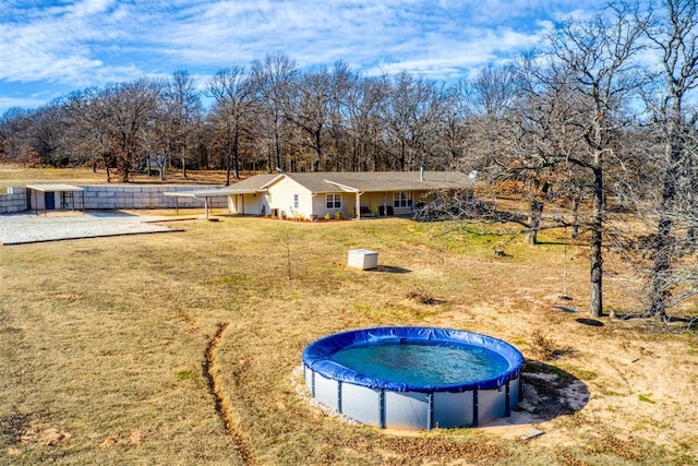 exterior space featuring a lawn and a covered pool