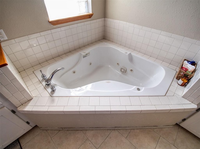 bathroom featuring tile patterned flooring and a bathtub