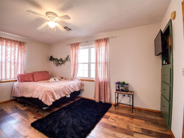 bedroom featuring hardwood / wood-style floors and ceiling fan