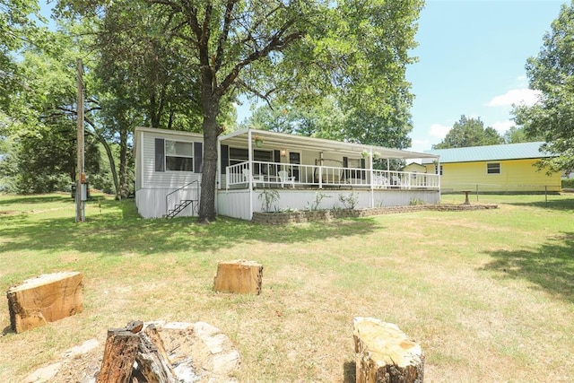 rear view of property with a deck and a lawn