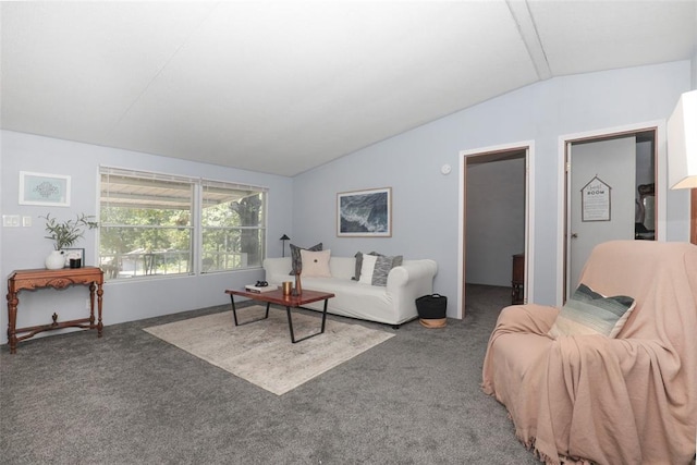 living room with dark colored carpet and vaulted ceiling